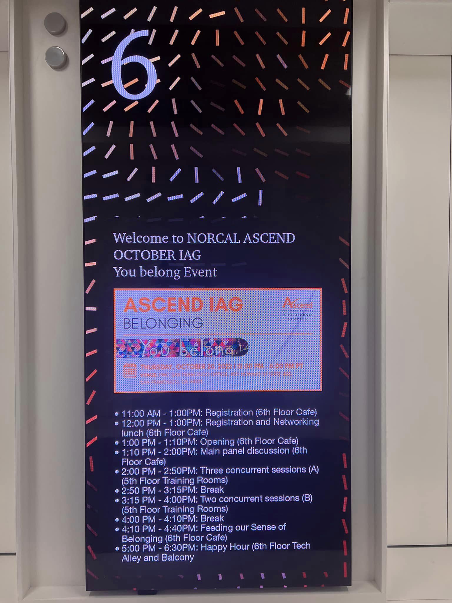 An image of a digital sign displaying information in a hallway.